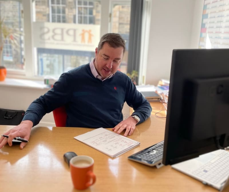Paul Brett-Smith at his desk in the PBS office