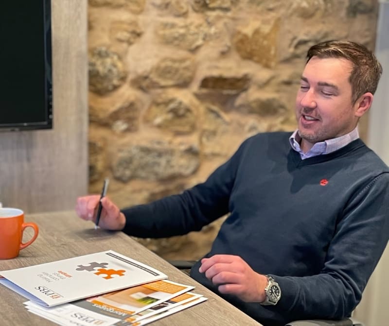 Paul Brett-Smith talking with a client in the PBS office